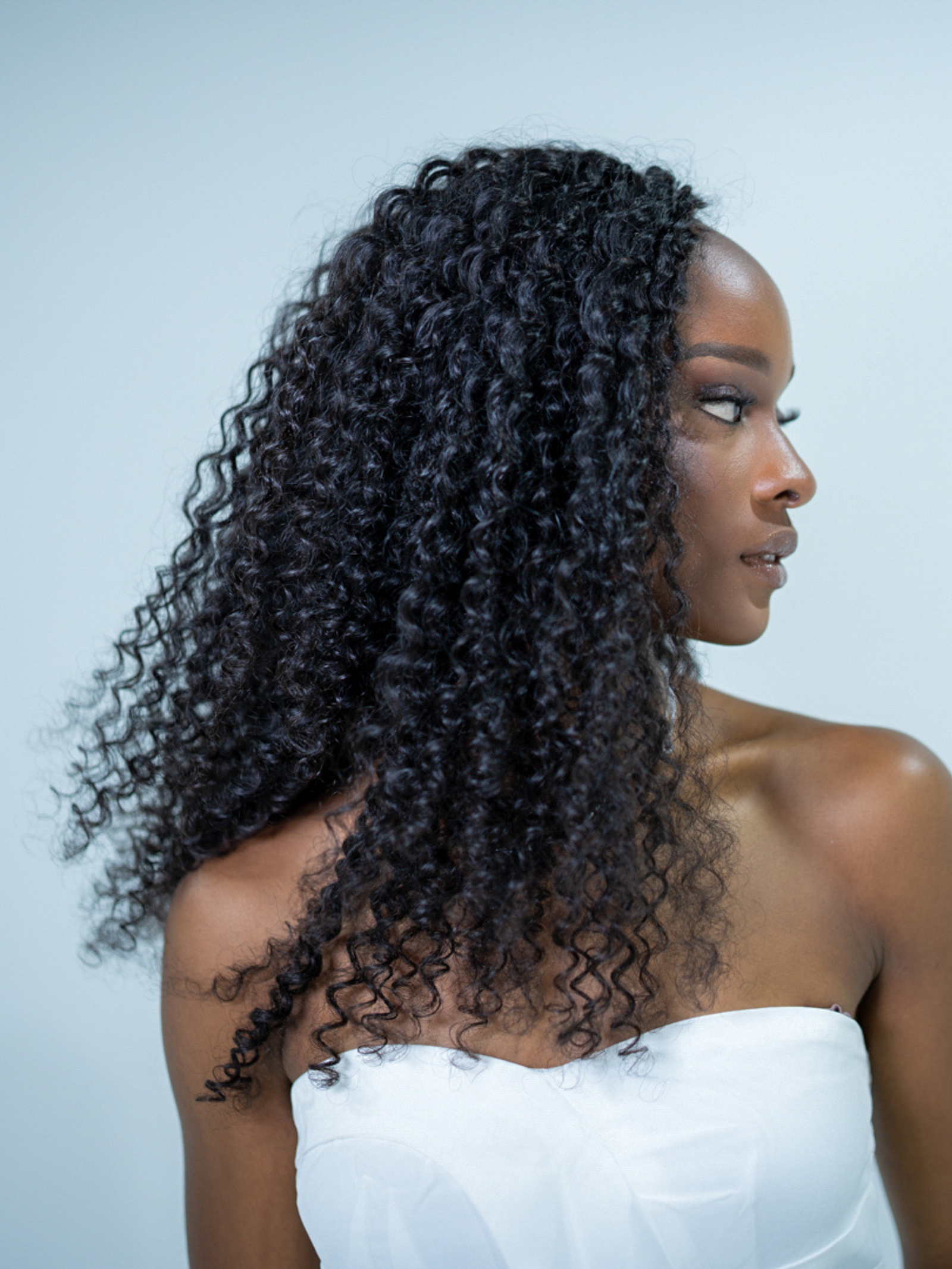 woman wearing curly human hair crochet extensions